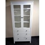 An Ikea painted pine double door bookcase fitted three drawers beneath