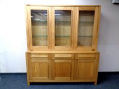 A Marks & Spencer Furniture contemporary oak triple door display cabinet fitted with cupboards and