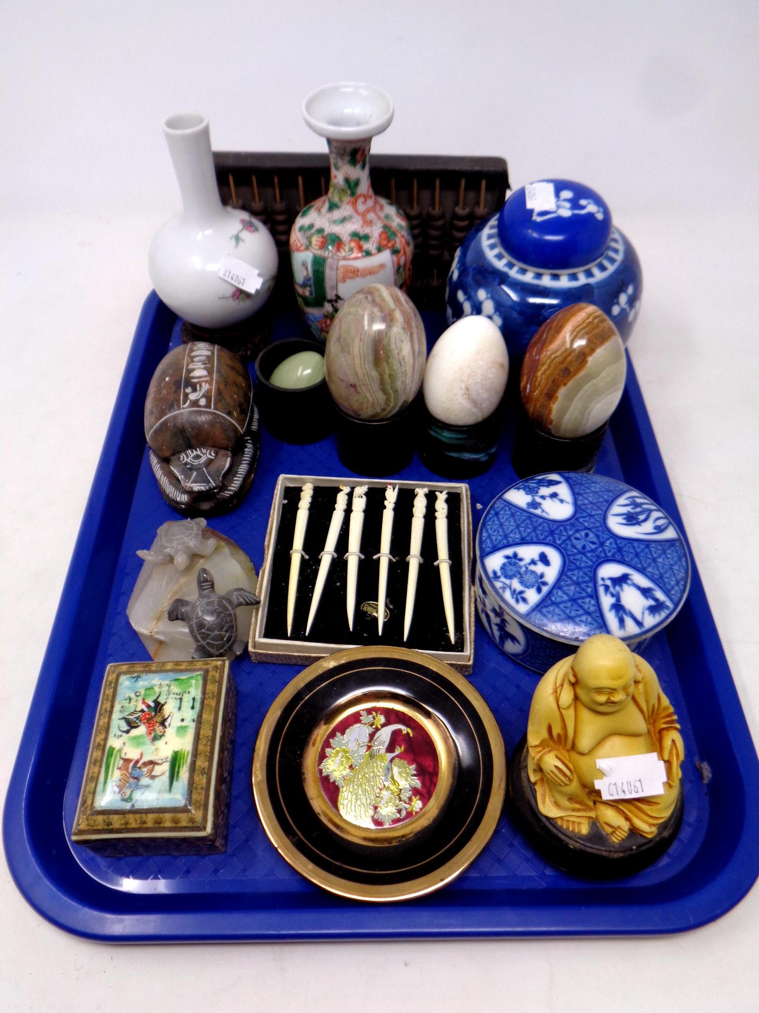 A tray containing eastern wares to include oriental vases, porcelain lidded ginger jar,