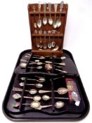 A tray containing a quantity of continental silver and plated crested and tourist teaspoons on
