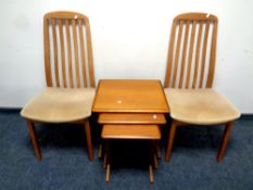 Two 20th century teak rail back dining chairs and a nest of teak tables