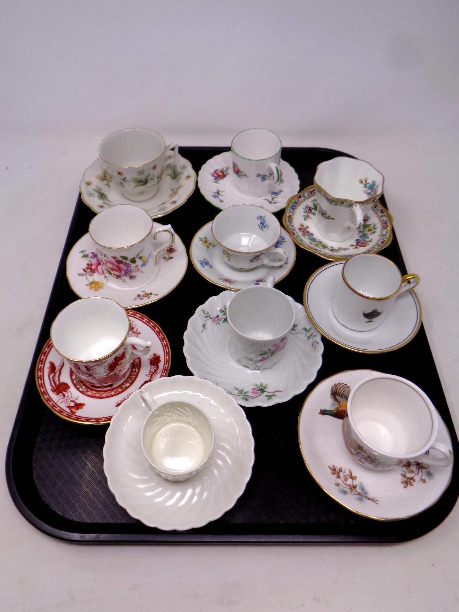 A tray containing ten assorted tea and coffee cups with saucers to include Royal Doulton, Coalport,