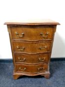 A mahogany serpentine fronted four drawer chest with brass dropped handles,