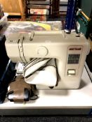 A Janome New Home electric sewing machine with foot pedal