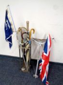 A brass and cast iron stick stand containing assorted parasols, walking sticks,