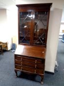 An Edwardian mahogany bureau bookcase fitted three drawers below