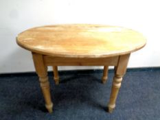 An antique oval pine table,