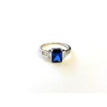 A sterling silver Art Deco style ring set with a blue stone, size N.