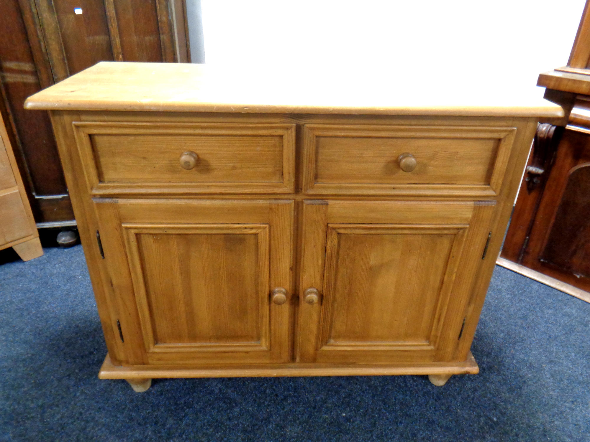 A farmhouse pine double door sideboard fitted two drawers above,