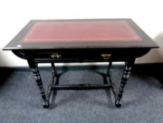 An Aesthetic Period ebonised writing table with a leather inset panel fitted a drawer,