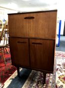 A mid 20th century teak writing bureau fitted cupboards beneath, width 68.