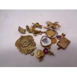 A gold plated fob together with pendants,