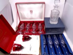 A Bohemian crystal whisky decanter, boxed, together with four further lead crystal champagne flutes,