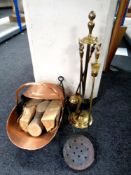 A copper and brass coal helmet together with a four piece brass companion set on stand a chestnut
