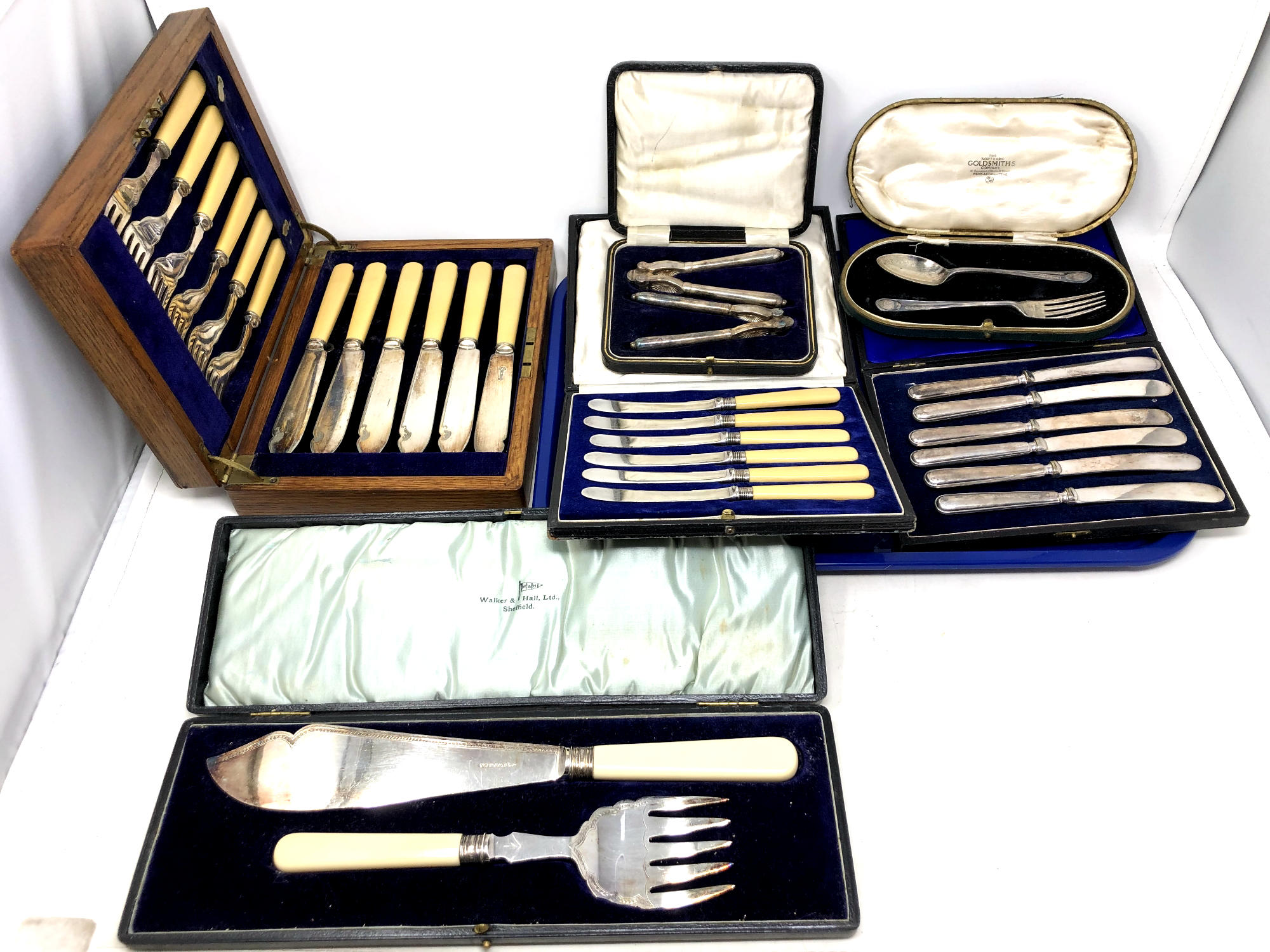 A tray containing cased silver fork and spoon, set of six silver handled butter knives,