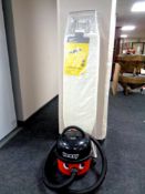 A Henry vacuum with hose together with an ironing board (new)