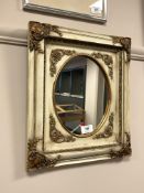 A contemporary cream and gilt mirror, overall 39cm by 34cm.