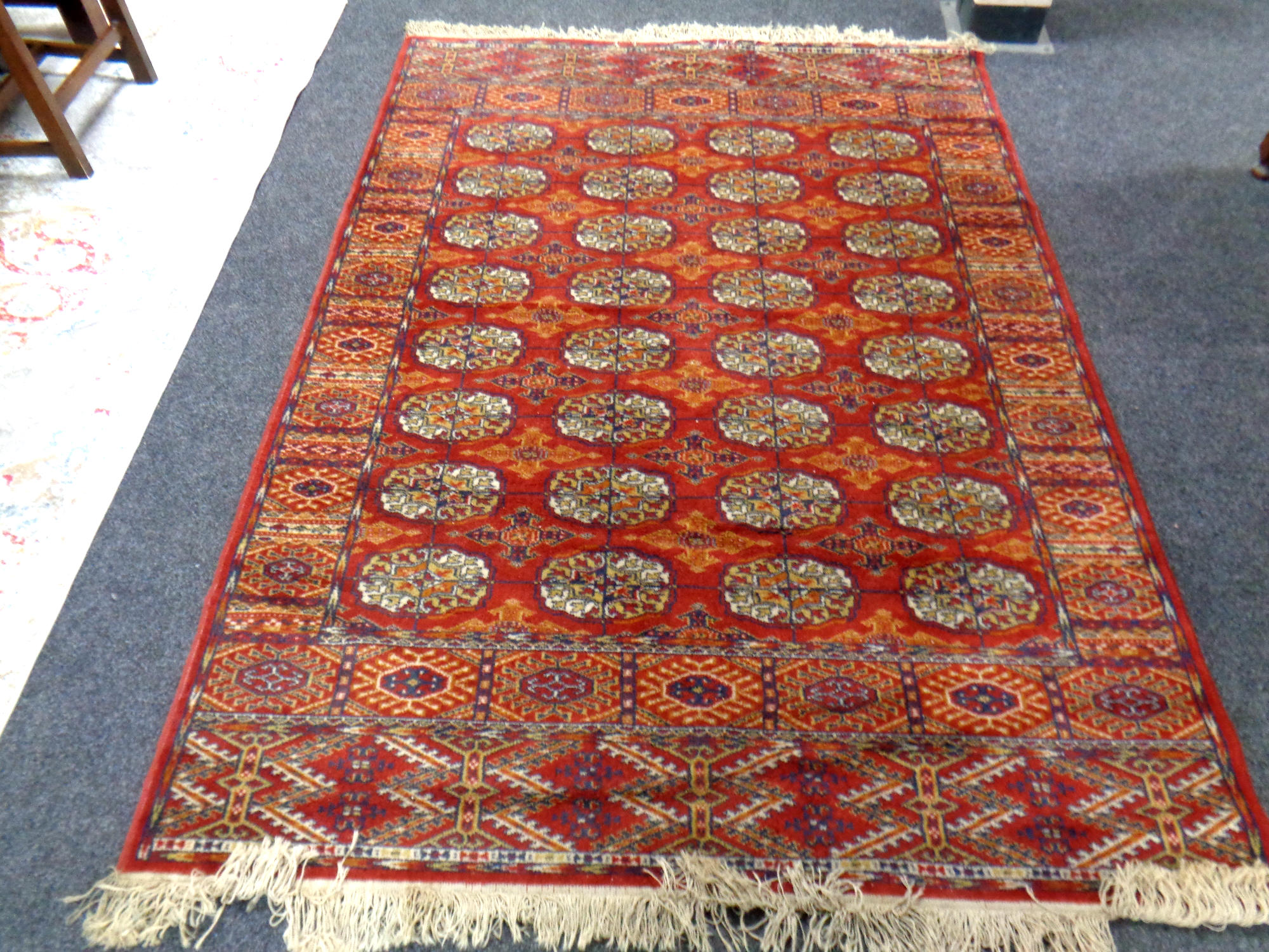 A machine made Bokhara design fringed rug,