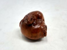 A Japanese carved fruitwood netsuke - Rats on a barrel.