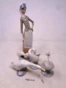 Three Lladro duck figures together with a further Lladro figure,