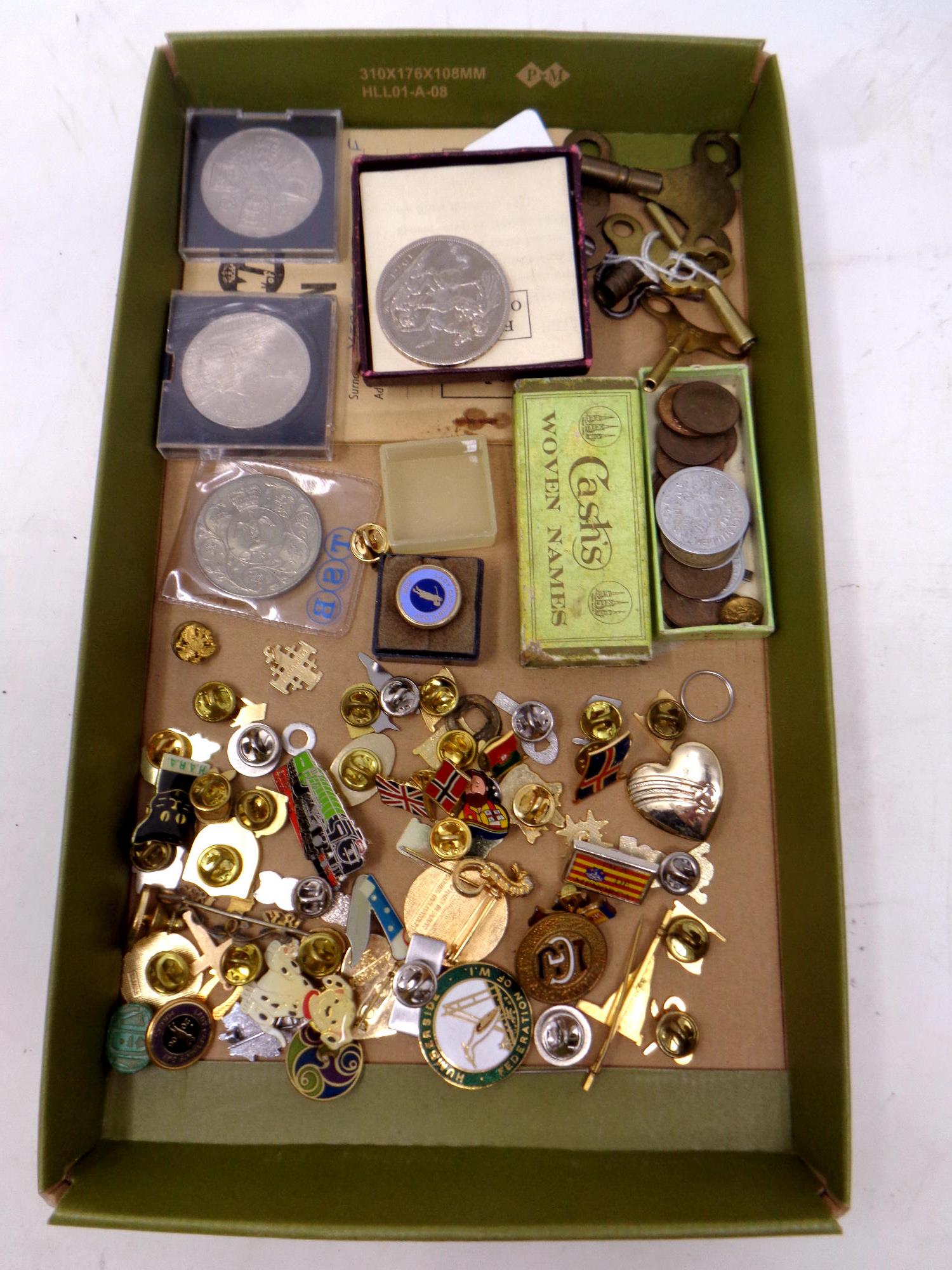 A box containing a collection of assorted enamelled badges,
