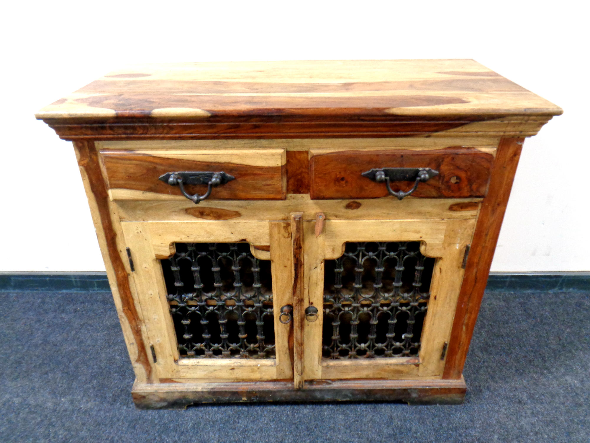 A mango wood double door cabinet fitted two drawers above,