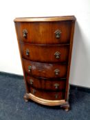 A walnut bow fronted narrow five drawer chest,
