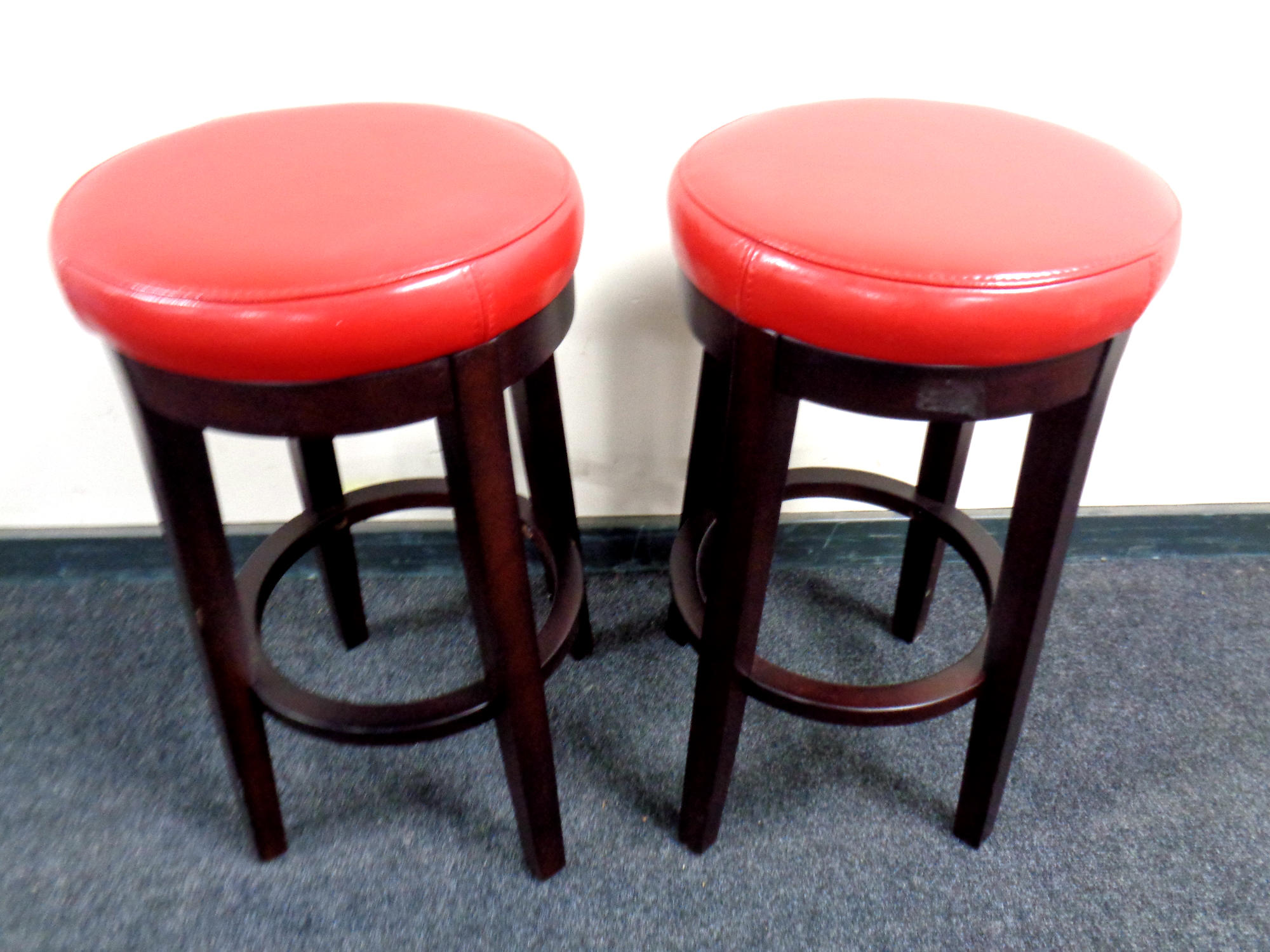 A pair of contemporary circular breakfast bar stools