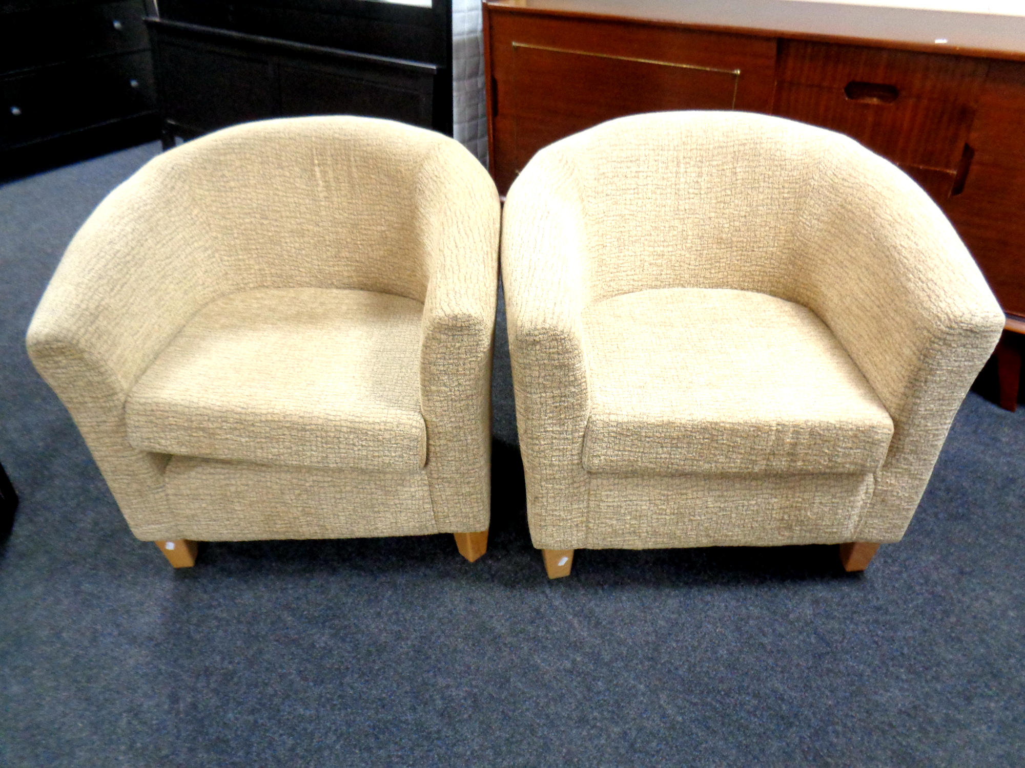 A pair of contemporary fabric upholstered tub chairs