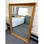 An ornate gilt framed overmantel mirror