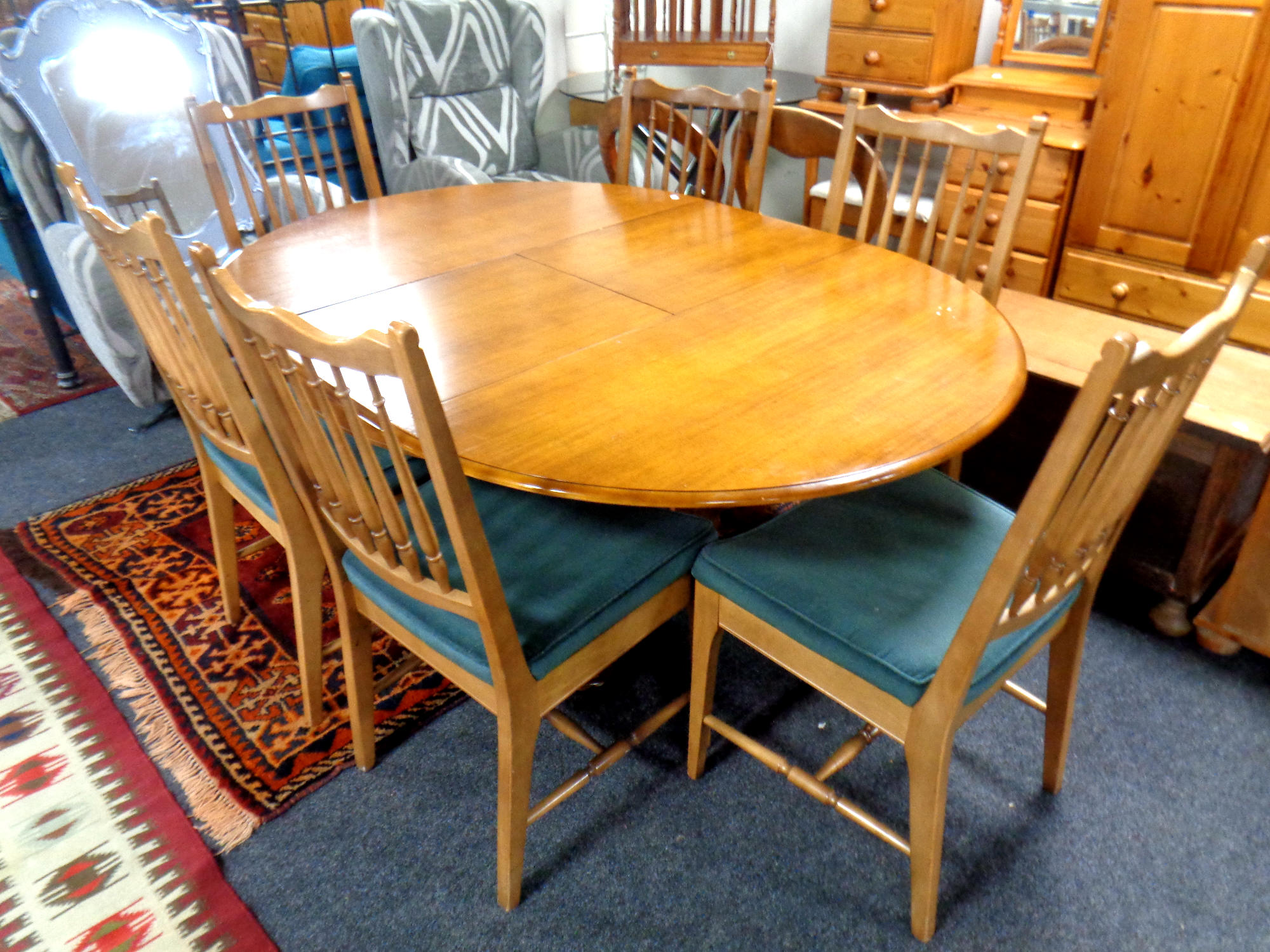 A circular teak extending dining table with leaf, length 160 cm,