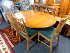 A circular teak extending dining table with leaf, length 160 cm,
