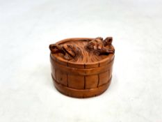 A Japanese carved fruitwood netsuke - Two turtles on a barrel.