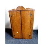 A 19th century oak double door hanging corner cabinet