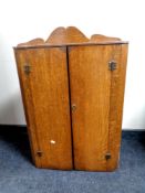 A 19th century oak double door hanging corner cabinet