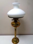 A Duplex brass oil lamp with opaque glass shade and chimney