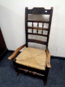 An antique beech rush seated kitchen rocking chair