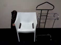 A contemporary white moulded plastic armchair together with a folding chair in carry bag,