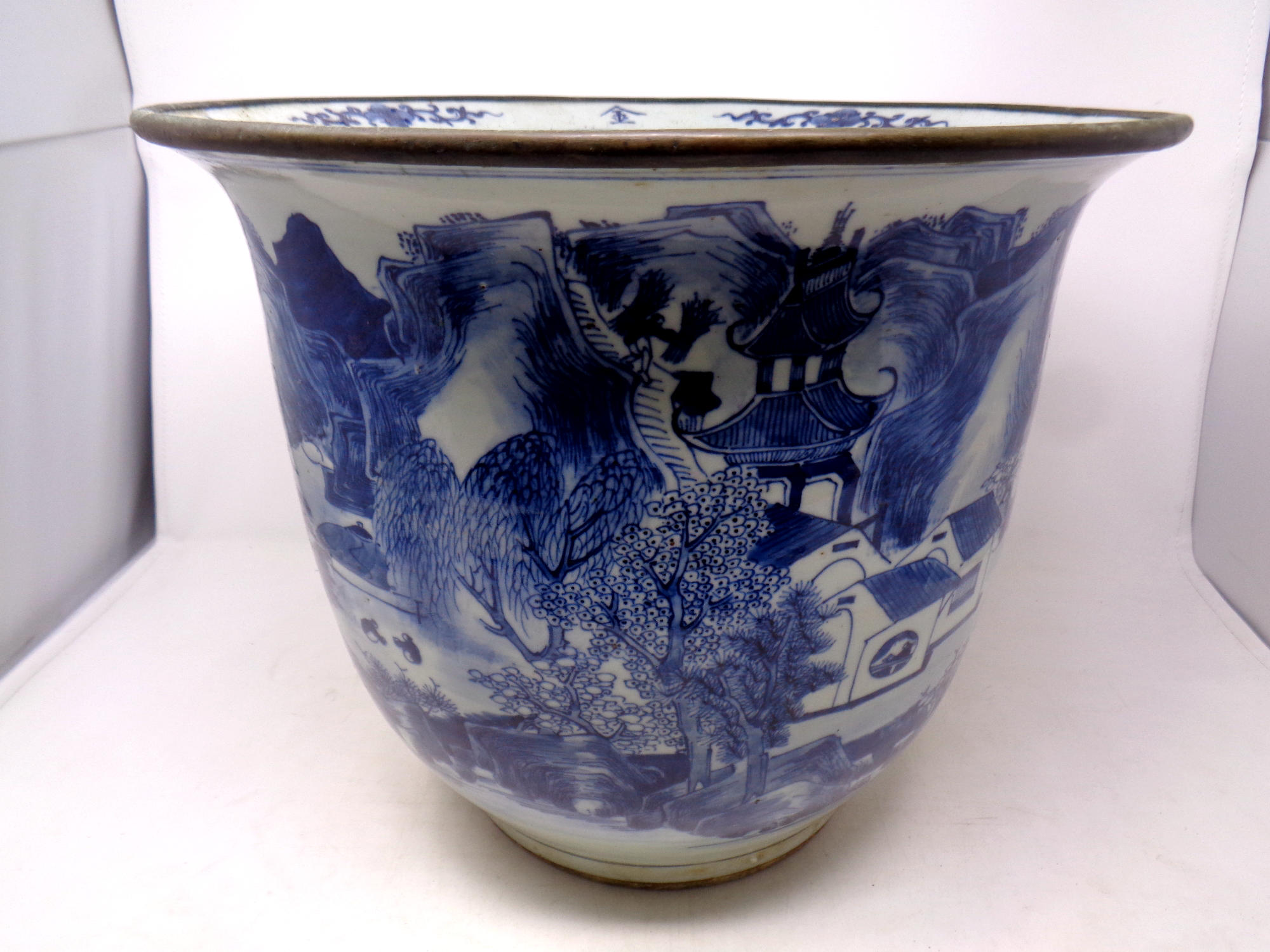 A Chinese blue and white planter depicting traditional scenes, width 37.