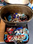 A 19th century tin hat box containing a large quantity of assorted costume jewellery