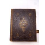 A 19th century leather bound Browns self interpreting family bible with colour lithographic book