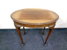 An Edwardian mahogany Heirloom oval occasional table on claw and ball feet