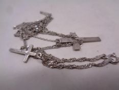 Two silver crosses on chains