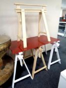 A pair of Ikea trestle stands together with a red glass top