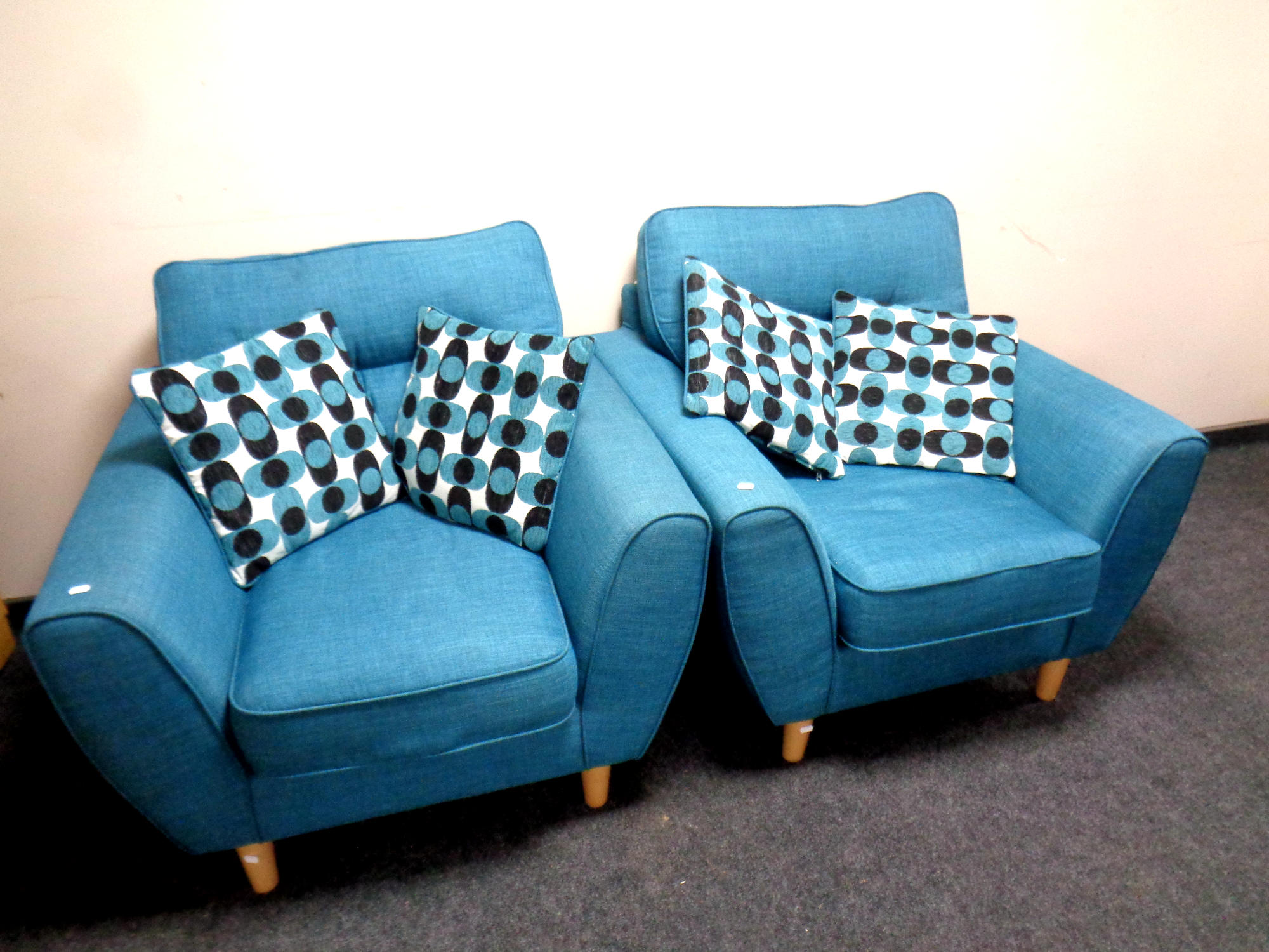 A pair of contemporary lounge armchairs upholstered in a turquoise fabric together with four