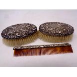 Two silver backed brushes and a silver mounted comb