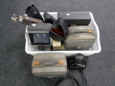 A box containing Nikon FG-20 camera with lens, camera tripods, slide viewers,