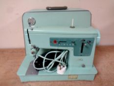 A 20th century Singer Model 337 electric sewing machine with foot pedal in case