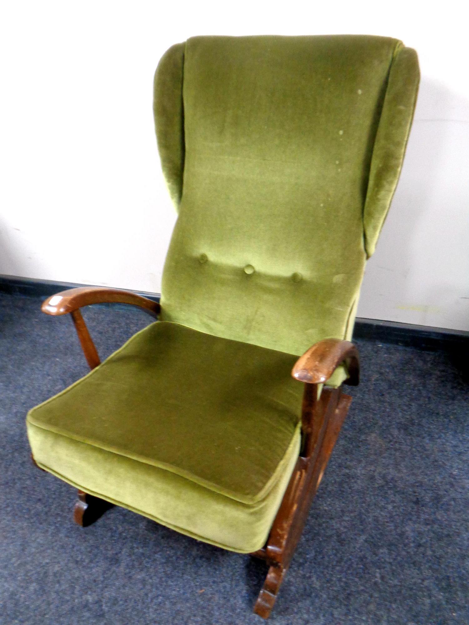 A mid 20th century rocking chair upholstered in a green dralon