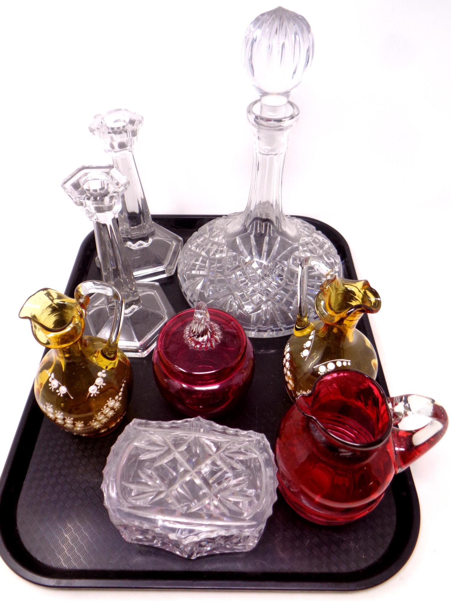 A tray containing antique and later glassware to include cranberry glass jug and lidded pot,